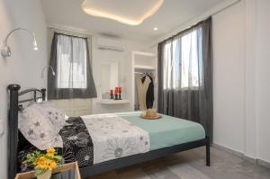 a bedroom with a bed and a bathroom with a shower at Depis suites in Naxos Chora