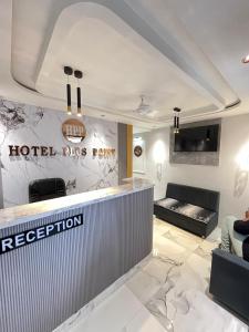 a hotel room with a reception counter and a hotel pits return at Hotel Plus Point in Ahmedabad