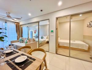 a room with a dining table and a bedroom at The Sóng Condotel Hao's Homestay in Vung Tau +71 photos