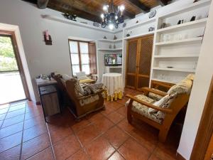 a living room with two chairs and a table at La Casina del Arroyo in Poo de Cabrales
