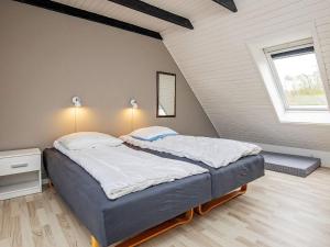 a bedroom with a large bed in a attic at 8 person holiday home in Fur in Fur