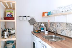 a kitchen with a sink and a counter at Family House GO TO - Parking & Dog Yard in Kavarna +23 photos
