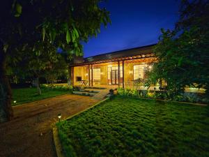a house is lit up at night at Angirasa Luxury Camping in Hyderabad