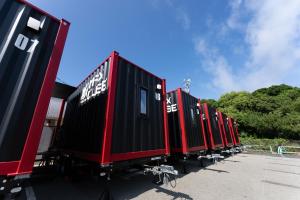 a row of train cars parked in a parking lot at MAX CUBE Inami Seafront in Inami +41 photos