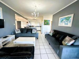 a living room with a couch and a table at Tahiti Dreaming in Umdloti