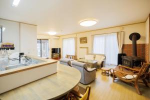 a living room with a kitchen and a living room with a stove at Hot Spring Cottage "Stella" - Zao Sansuien - Gaia - Vacation STAY 54020v in To-katta