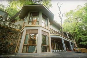 a house with a large window on top of it at Liuchunwu Resort in Tianmu Mountain in Menkou