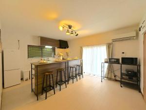 a kitchen with a counter and bar with stools at Ashigarashimogun - House - Vacation STAY 17328 in Miyakami
