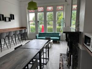 a bar with a couch and a table in a room at En-suit Triple Double & Single Rooms Near LFC Anfield Free Street Parking 24-7 in Liverpool +15 photos