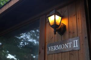 a light on the side of a building with a sign at Kitakaruizawa Sweet Grass - Vacation STAY 22104v in Kita-karuizawa +5 photos