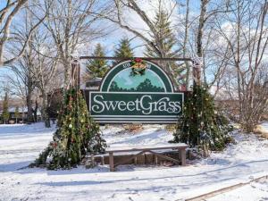 a sign for a sweetgrass sign in the snow at Kitakaruizawa Sweet Grass - Vacation STAY 22104v in Kita-karuizawa