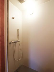 a shower in a bathroom with a light on the wall at Kitakaruizawa Sweet Grass - Vacation STAY 22104v in Kita-karuizawa