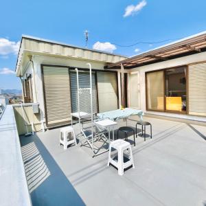 a patio with a table and chairs on a balcony at Makeit 1to3 - Vacation STAY 17356 in Chichibu