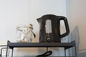 a black coffee maker and a blender on a shelf at IG3 Oyado Sankan Shion - Vacation STAY 61821v in Ito