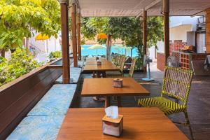 a row of tables and chairs on a patio at Samed Seaside Resort in Ko Samed