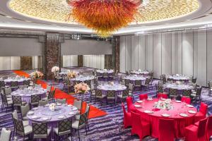 a banquet hall with tables and chairs and a chandelier at Sheraton Grand Taipei Hotel in Taipei