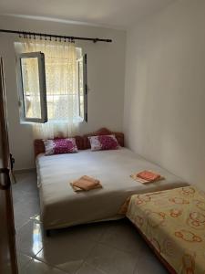 a bedroom with a large bed and a window at Sutomore Ivana Ratac in Sutomore