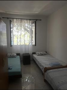 a bedroom with two beds and a window at Sutomore Ivana Ratac in Sutomore