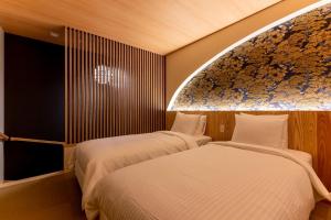 a bedroom with two beds and a large window at Oyado michi - Vacation STAY 55924v in Sasebo