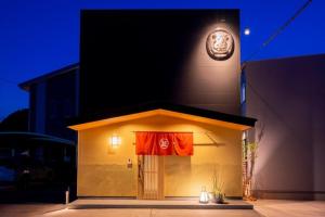 a building with a flag on the side of it at Oyado michi - Vacation STAY 55924v in Sasebo