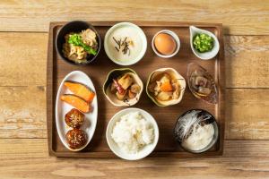 a tray of food with bowls of different types of food at HOTEL MYSTAYS Utsunomiya in Utsunomiya