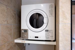 a washing machine on a shelf in a bathroom at Oyado michi - Vacation STAY 47702v in Sasebo