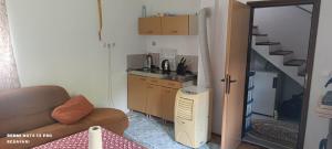 a living room with a couch and a sink and a kitchen at Faris in Bihać