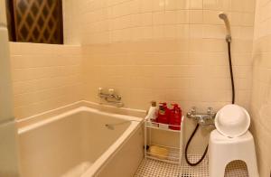 a bathroom with a bath tub and a toilet at Yatsugatake Villa FOREST&DOG - Vacation STAY 53545v in Hokuto +11 photos
