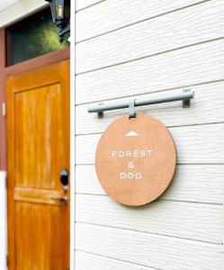 a sign on the side of a house with a door at Yatsugatake Villa FOREST&DOG - Vacation STAY 53545v in Hokuto