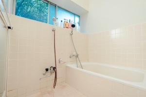 a bathroom with a shower and a bath tub at SLOW HOUSEkesennuma 102,103 - Vacation STAY 72219v in Kesennuma