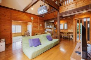 a living room with a couch in a room with wooden walls at Pets allowed, natural hot spring rental villa "Yuy - Vacation STAY 54103v in To-katta