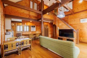 a living room with a couch and a television at Pets allowed, natural hot spring rental villa "Yuy - Vacation STAY 54103v in To-katta