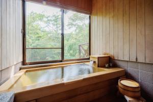 a bath tub in a bathroom with a window at Pets allowed, natural hot spring rental villa "Yuy - Vacation STAY 54103v in To-katta