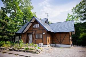 a wooden house with a black roof at Pets allowed, natural hot spring rental villa "Yuy - Vacation STAY 54103v in To-katta