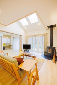 a living room with a couch and a fireplace at ZAO Hotaru no niwa - Vacation STAY 54095v in To-katta