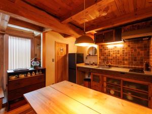 a kitchen with a wooden table in a room at Kakurega STAY Kurahinawara - Vacation STAY 74839v in Kyōmendao