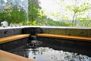 a koi pond in a room with a window at Rental villa with natural hot spring "NEGURA" - Vacation STAY 54178v in To-katta +9 photos