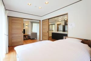 Ένα ή περισσότερα κρεβάτια σε δωμάτιο στο Rental villa with open-air hot spring bath "Rioren - Vacation STAY 54190v