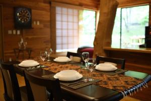 una sala da pranzo con un tavolo con piatti e bicchieri da vino di Four Seasons Oasis MIYAGI ZAO - Zao Sansuien - Gai - Vacation STAY 54220v a To-katta Altre 16 foto