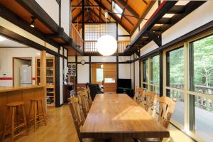 una grande sala da pranzo con tavolo e sedie in legno di U pause - Rental villa with natural hot spring - Vacation STAY 54202v a To-katta