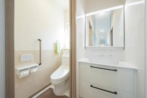 a bathroom with a toilet and a sink and a mirror at Guest House Aji Nakaniwa - Vacation STAY 17513 in Takamatsu +9 photos
