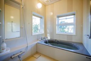 a bathroom with a large tub and a window at Private cottage with wood stove [Senichi no Yado] - Vacation STAY 54169v in To-katta +61 photos