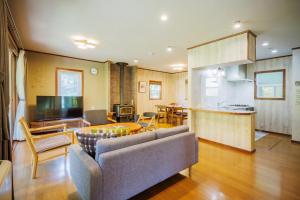 a living room with a couch and a table at Private cottage with wood stove [Senichi no Yado] - Vacation STAY 54169v in To-katta