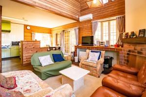 a living room with a couch and a chair at Kattagun - House - Vacation STAY 17460 in To-katta +6 photos