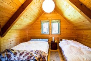 two beds in a room in a log cabin at Shibatagun - House - Vacation STAY 17461 in Aone