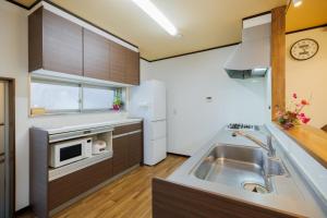 a kitchen with a sink and a microwave at Shibatagun - House - Vacation STAY 17462 in Murata +18 photos