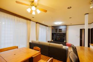 a living room with a table and a ceiling fan at Shibatagun - House - Vacation STAY 17462 in Murata