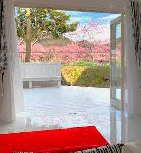 a red rug in front of a sliding glass door at Sea Shell Kawazu House - Vacation STAY 55091v in Kawazu