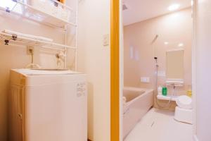 a bathroom with a sink and a toilet and a tub at Muratamachi bukeyashiki- Gaia Resort - Vacation STAY 54893v in Murata +43 photos