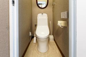 a bathroom with a toilet with a mirror at TwinB Building 5 Haruoka 2F - Vacation STAY 17506 in Nagoya +12 photos